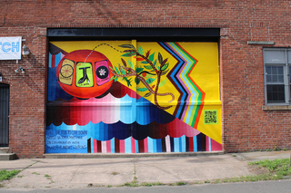Photo of a bright colored mural named Take the Risk to Cool Down.