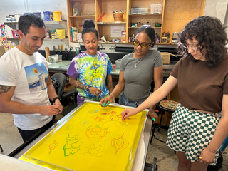 A Group of four apprentices in art workshop to develop skillset.